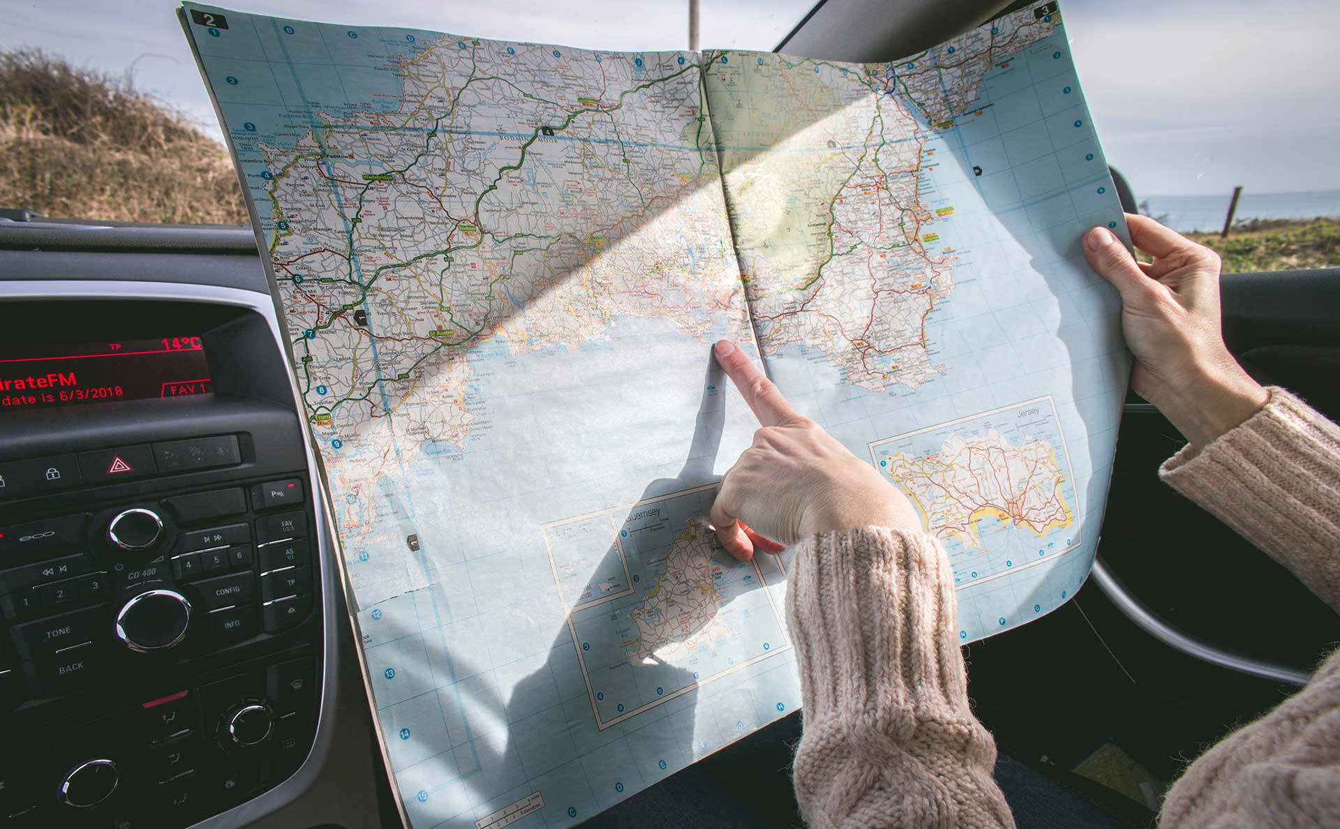 Person pointing to a physical map